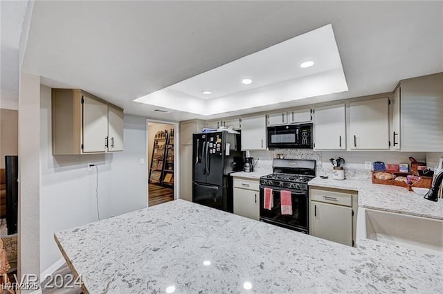 478 Potomac St, Henderson, NV 89015 - kitchen with a sink, black appliances, a peninsula, and a raised ceiling
