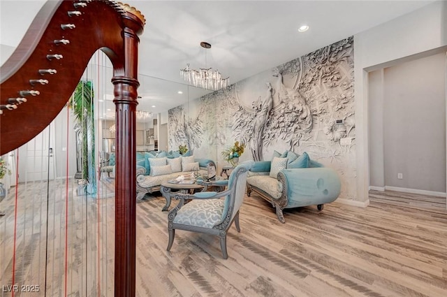 interior space with a notable chandelier, baseboards, wood finished floors, and recessed lighting