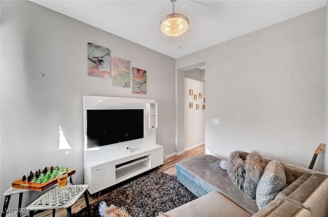 living room with baseboards and wood finished floors