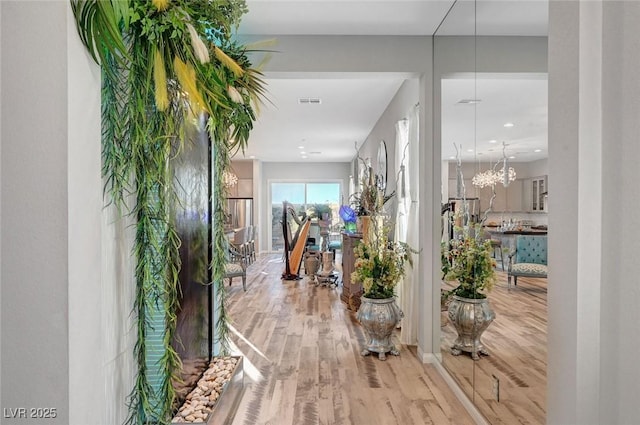 foyer entrance with visible vents and wood finished floors