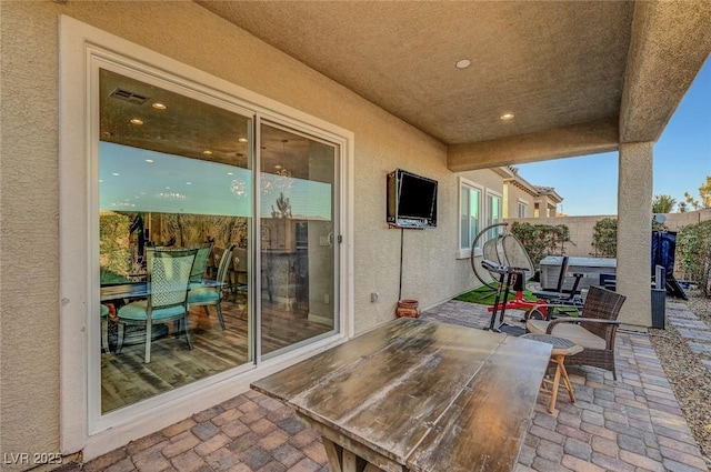 view of patio with visible vents and fence