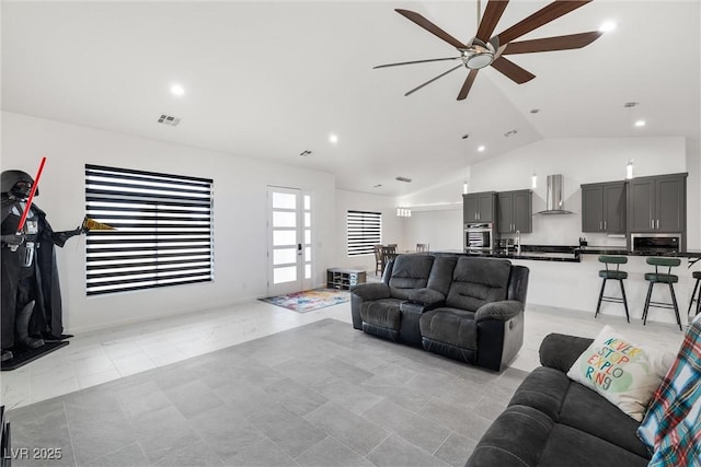 living area with lofted ceiling, ceiling fan, visible vents, and recessed lighting