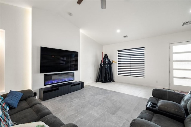 living room with ceiling fan, visible vents, vaulted ceiling, and baseboards