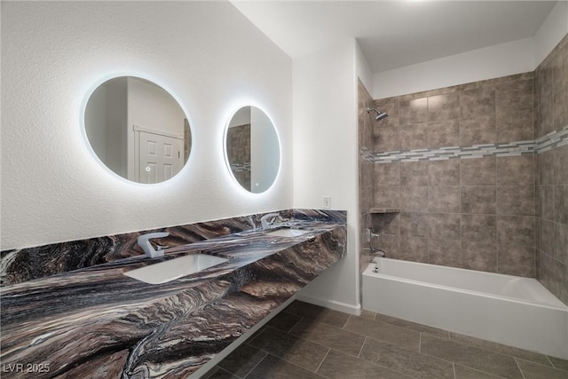 full bath featuring double vanity, shower / washtub combination, a sink, and tile patterned floors