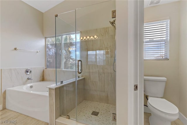 bathroom featuring a garden tub, visible vents, toilet, a stall shower, and wood finished floors