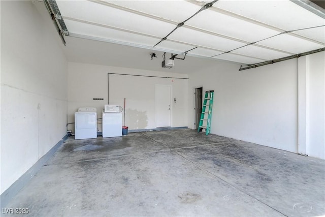 garage featuring a garage door opener and washing machine and clothes dryer