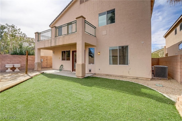 rear view of property featuring a fenced backyard, a patio, central AC, and stucco siding