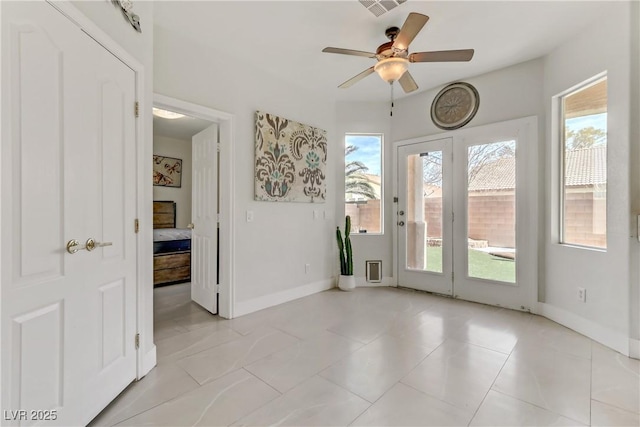 spare room with visible vents, baseboards, and a ceiling fan