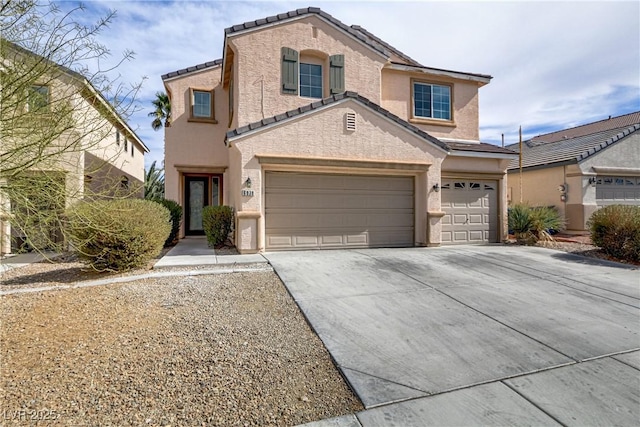 view of front of home featuring driveway, a tiled roof, and stucco siding