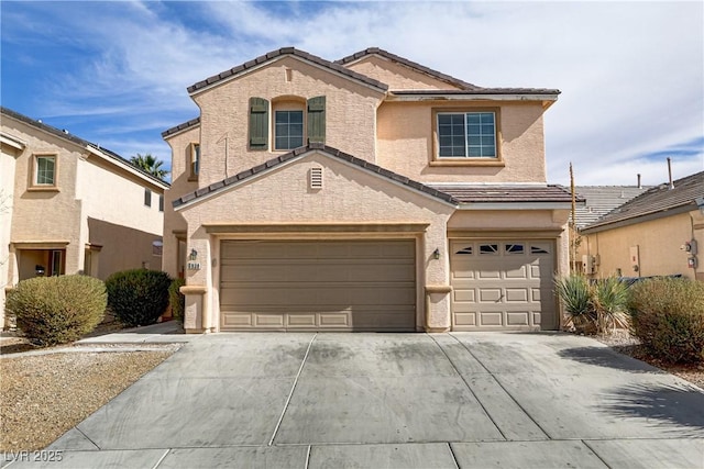 view of front of property featuring concrete driveway, an attached garage, a tiled roof, and stucco siding