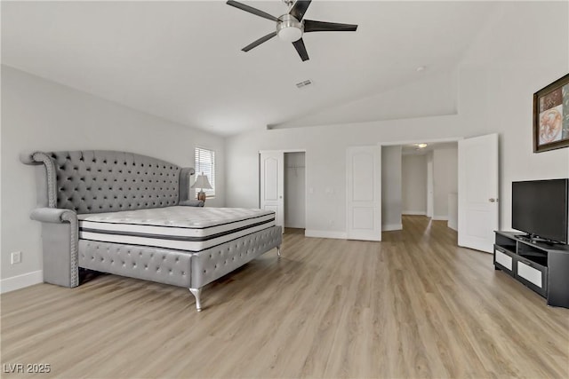 bedroom with vaulted ceiling, light wood-type flooring, visible vents, and baseboards