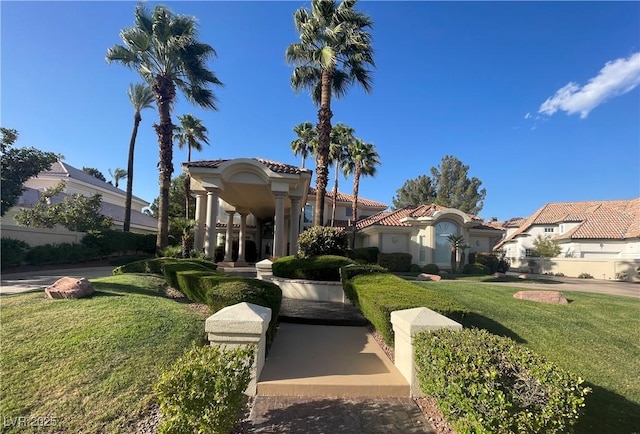 view of front of property featuring a residential view, a tiled roof, and a front lawn