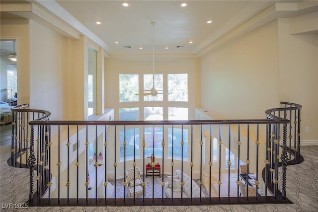 hallway featuring recessed lighting, baseboards, crown molding, and an upstairs landing