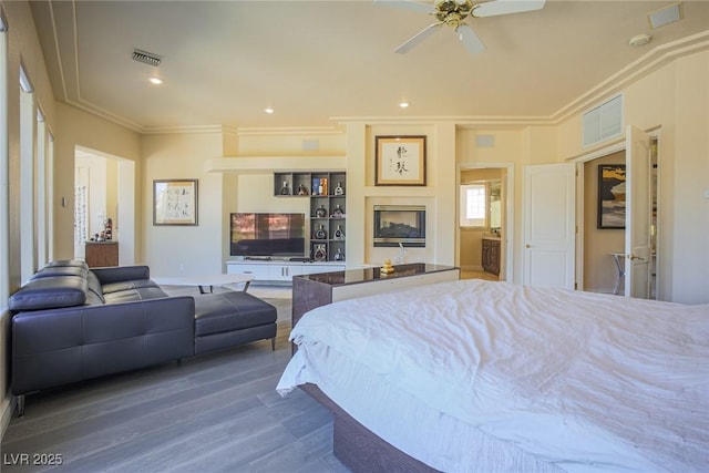 bedroom featuring visible vents, ornamental molding, wood finished floors, a fireplace, and recessed lighting