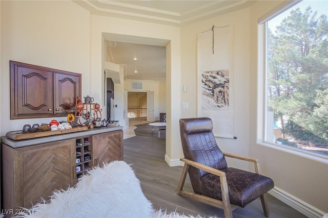 living area featuring dark wood-type flooring, visible vents, and baseboards