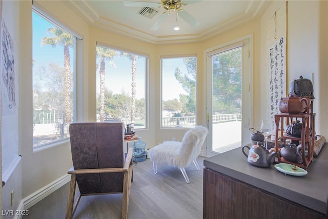 sunroom with visible vents and ceiling fan