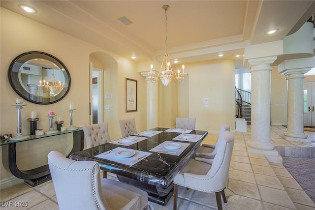 dining room featuring decorative columns, a tray ceiling, arched walkways, and recessed lighting