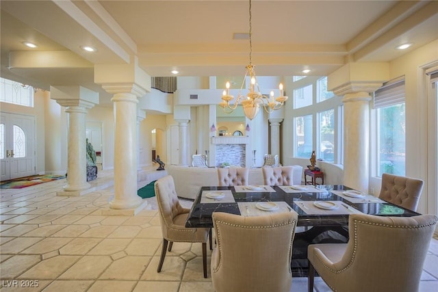 dining space featuring a chandelier, recessed lighting, visible vents, and ornate columns