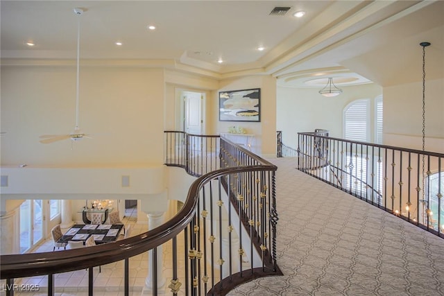 hallway with visible vents, an upstairs landing, and recessed lighting