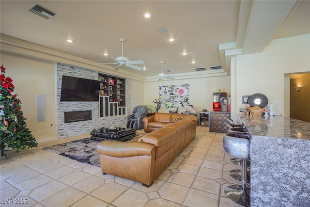 living area with recessed lighting, visible vents, a fireplace, and light tile patterned floors