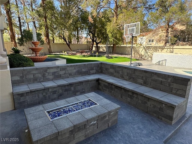 view of patio featuring a fire pit and fence