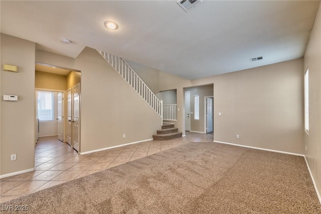 unfurnished room with light carpet, stairs, and visible vents