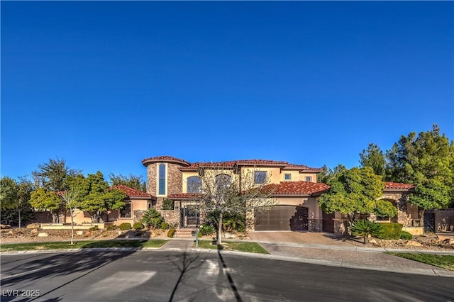 mediterranean / spanish house featuring driveway, a tiled roof, and stucco siding