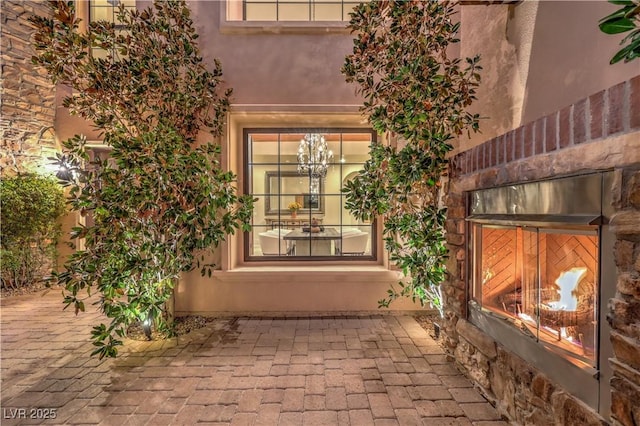 entrance to property featuring stucco siding