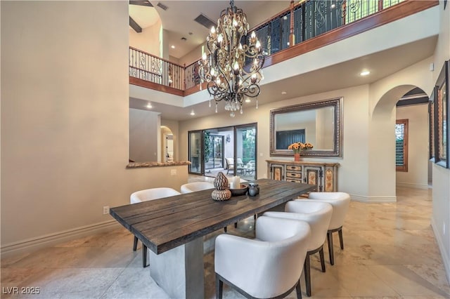 dining area with arched walkways, french doors, a healthy amount of sunlight, and baseboards