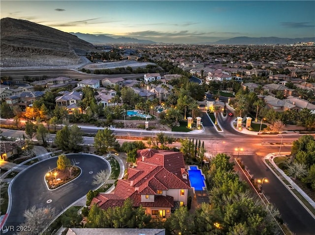 aerial view at dusk with a mountain view and a residential view