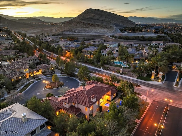 aerial view at dusk with a mountain view and a residential view