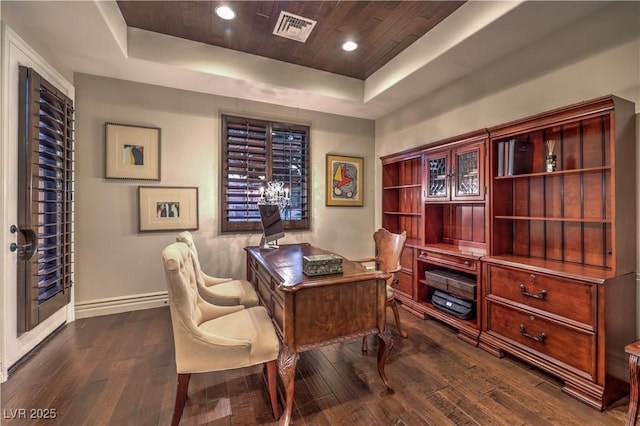 home office featuring visible vents, a raised ceiling, and dark wood finished floors