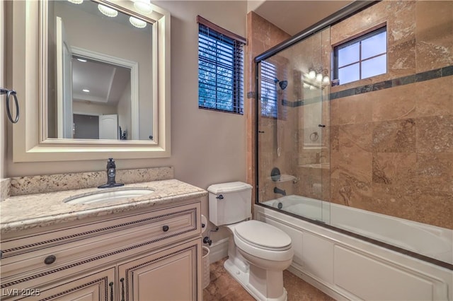 bathroom with toilet, enclosed tub / shower combo, and vanity