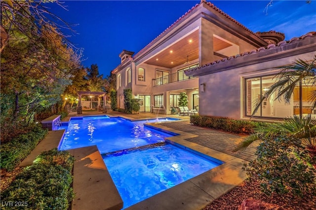 view of swimming pool with a pool with connected hot tub and a patio