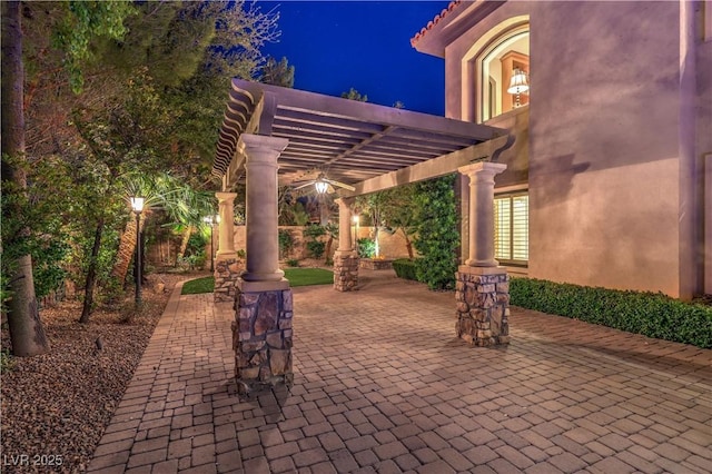 patio at twilight featuring a pergola