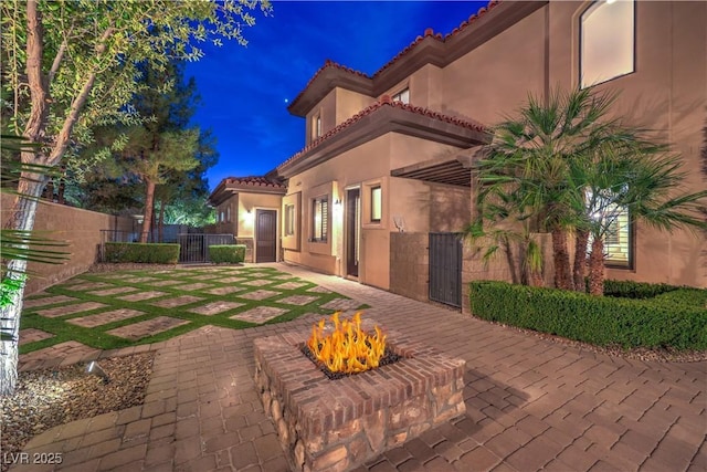 exterior space with an outdoor fire pit and fence private yard