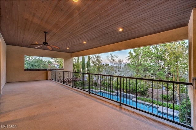 view of patio featuring ceiling fan and a swimming pool