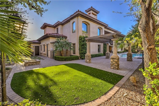 back of house featuring a tile roof, a patio, stucco siding, a pergola, and an outdoor pool