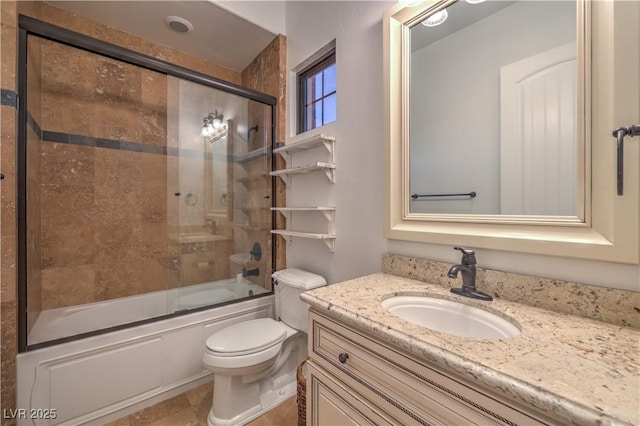 full bath featuring toilet, bath / shower combo with glass door, and vanity