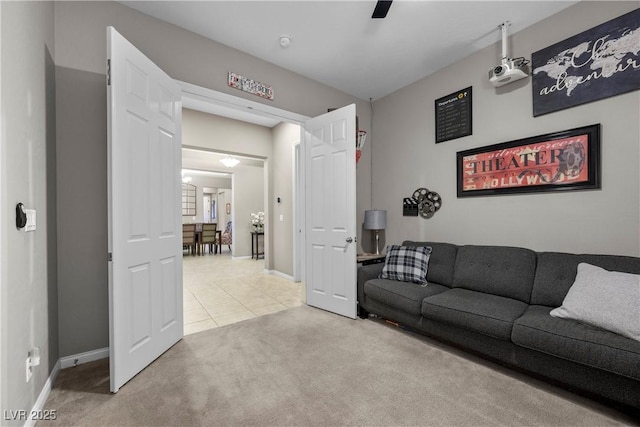 living room featuring light carpet, light tile patterned flooring, and baseboards