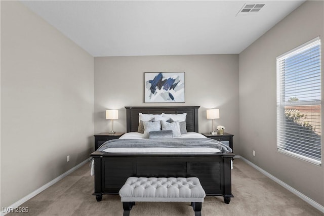 bedroom with baseboards, visible vents, and light colored carpet