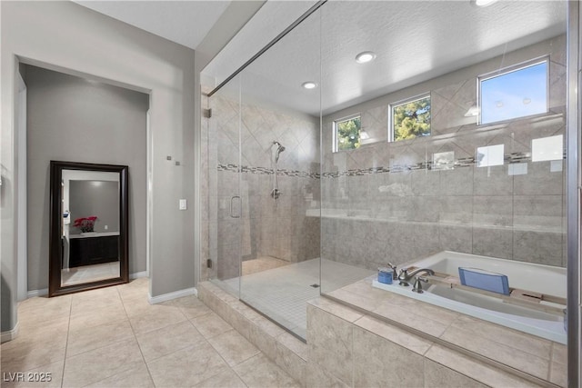 bathroom with a garden tub, tile patterned flooring, a shower stall, and baseboards