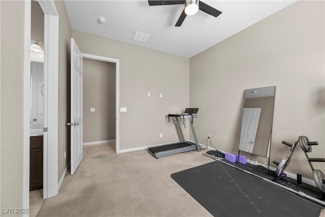 exercise room featuring baseboards, a ceiling fan, visible vents, and light colored carpet