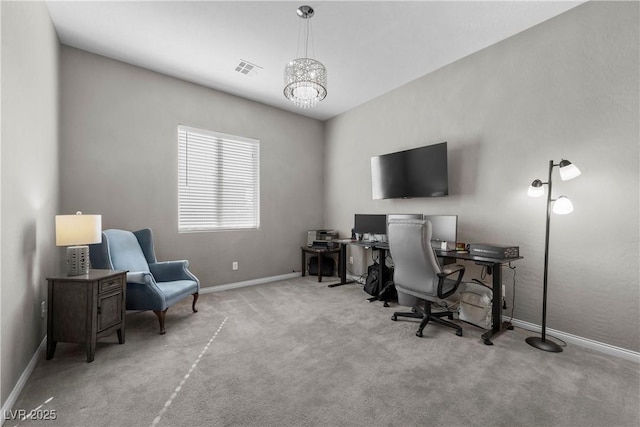 home office with light carpet, an inviting chandelier, baseboards, and visible vents