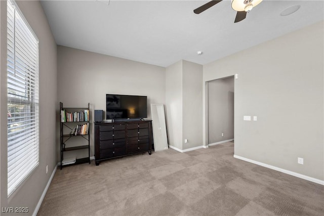 bedroom with baseboards, ceiling fan, and light colored carpet