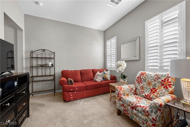 living room featuring light carpet and visible vents