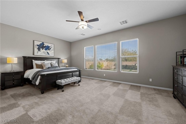 bedroom with light carpet, ceiling fan, visible vents, and baseboards