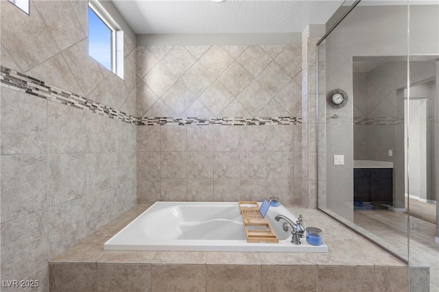 full bath featuring a garden tub and tile walls