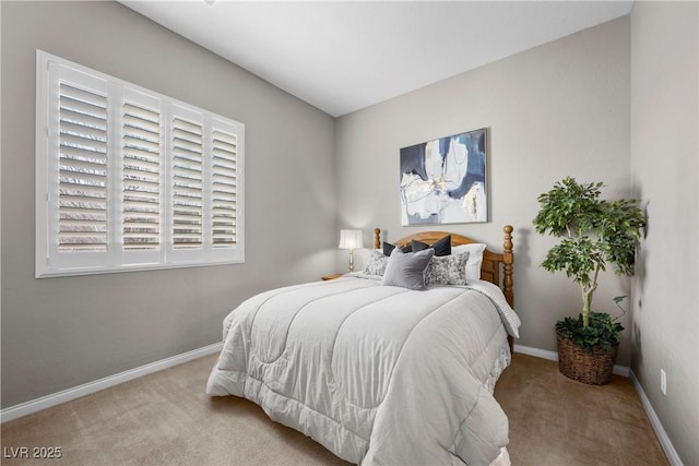 bedroom with light carpet and baseboards