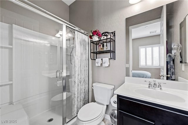 full bathroom featuring toilet, a shower stall, ensuite bath, and vanity